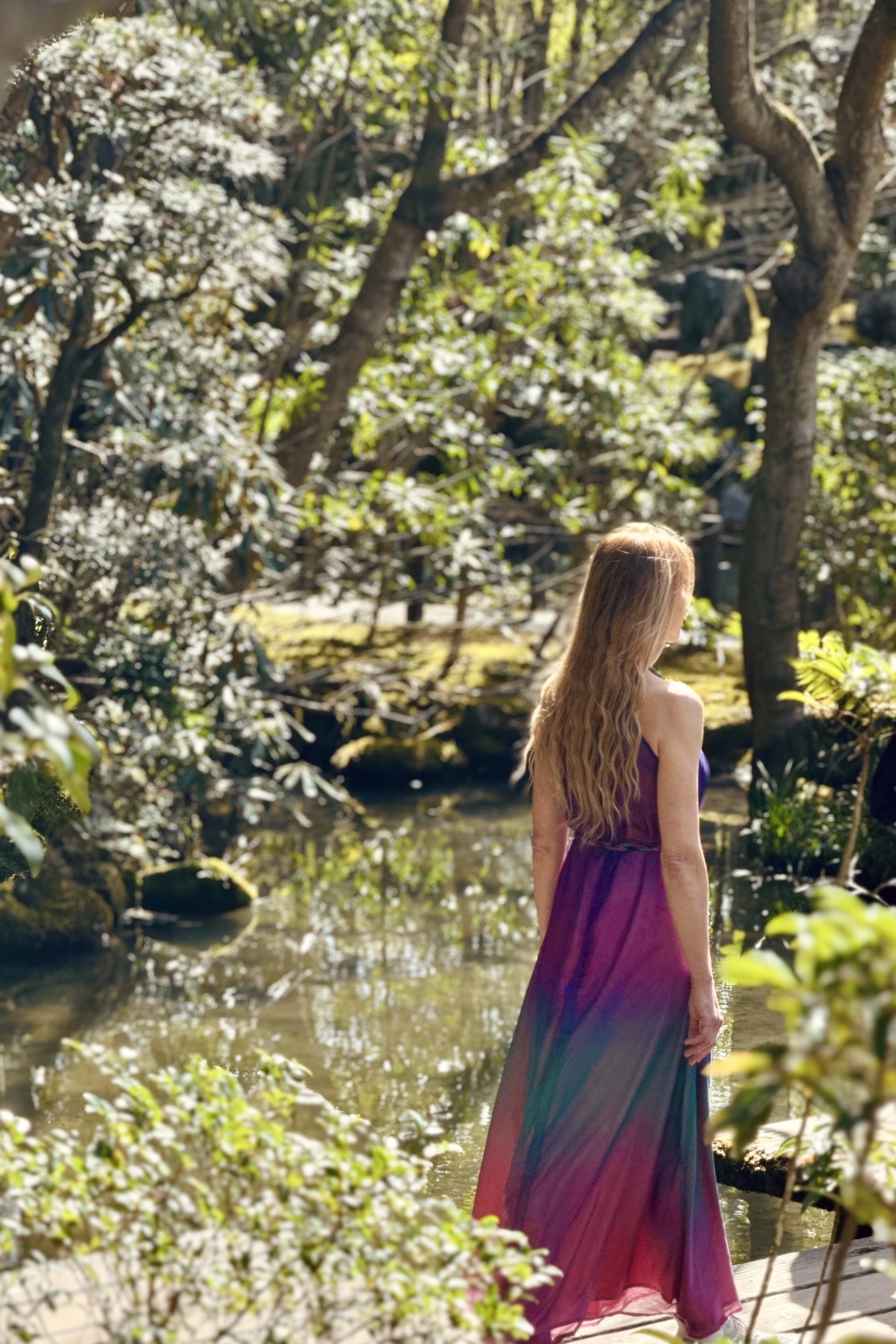 Muse beside a Kyoto pond